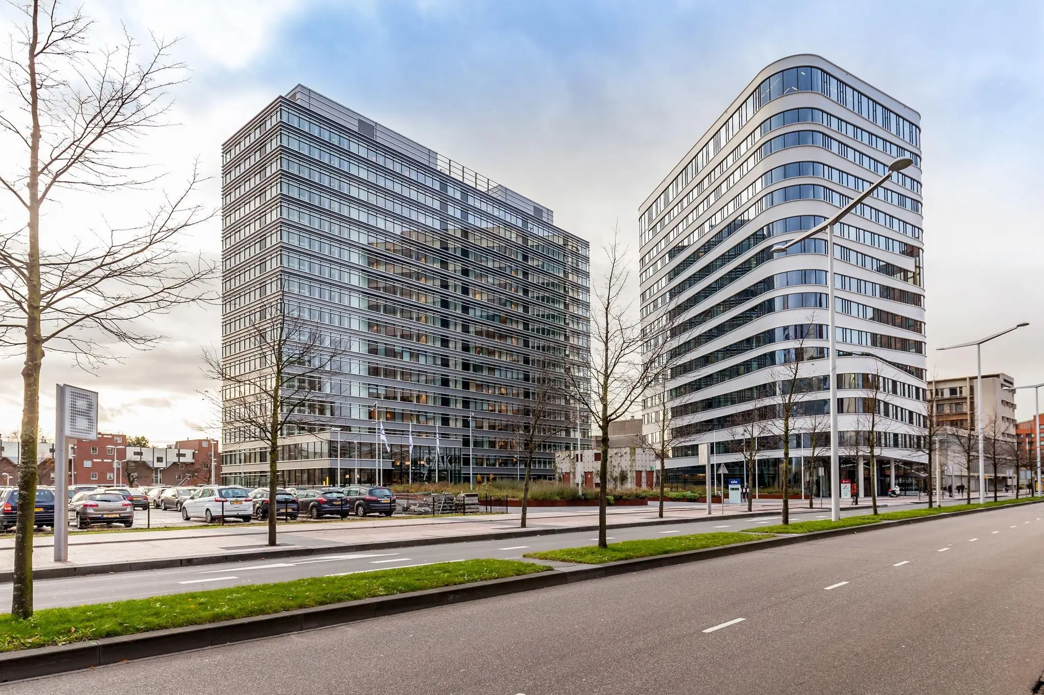 Twee moderne kantoorgebouwen aan de Prinses Beatrixlaan met een brede, lege weg op de voorgrond.